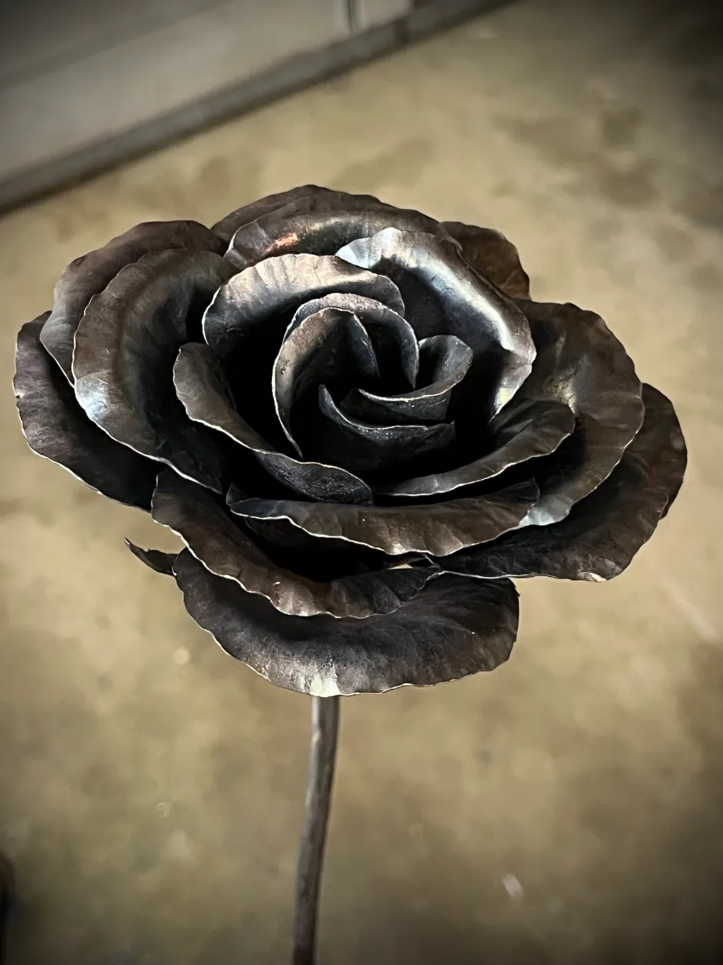 A rose forged from steel, petal by petal